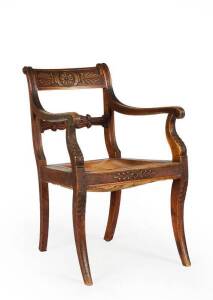 An Australian colonial cedar carver chair, after the style of Thomas Hope, early 19th century. Ornate carved decoration throughout, sabre legs.&nbsp;
