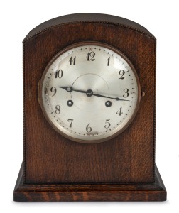A German oak cased table clock with two train time and strike movement, silvered dial with Arabic numerals, early to mid 20th century, 28cm high.