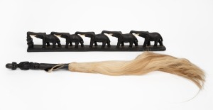 An African tribal fly whisk; together with a carved wood and bone elephant bridge ornament, (2 items), the bridge 59cm long.