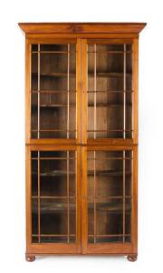 BOOKCASE: Mid 19th century cedar in the Sheraton style with 4 astragal doors. Most likely Tasmanian origin. Height 253cm, width 135cm, depth 48cm. Provenance: The Estate of the late Christopher Pearson Adelaide