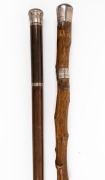 An antique walking stick with yucca shaft, brass ferrule, silver top and collar, engraved "Yucca, August 31st, 1906"; together with a vintage secret drinking stick with glass vial and miniature goblet, 20th century, (2 items), ​​​​​​​92cm and 86cm high.