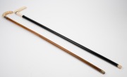 Two antique walking sticks with carved ivory handles, ebony and malacca shafts, (one with silver collar), 19th/20th century, 91cm and 92cm high. - 2