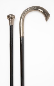Two antique walking sticks with silver tops and ebonised shafts, one example with brass ferrule and the other missing, 19th/20th century, 90cm and 91cm high.