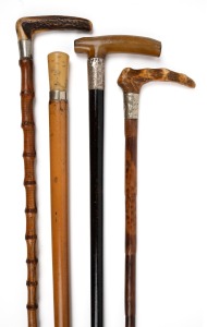 Four assorted antique and vintage walking sticks with silver and metal mounts, two examples with deer antler handles, one with horn and one with resin, 19th/20th century, the largest 88cm high.