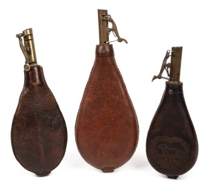 Three assorted antique leather and brass shot flasks, 19th century, the largest 26cm high.