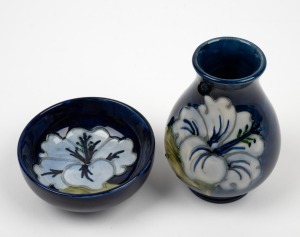 MOORCROFT English miniature pottery vase with floral decoration on blue ground; together with a matching bowl, (2 items), factory mark to base, the vase 9cm high.