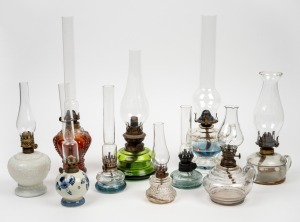 Ten assorted antique and vintage glass and porcelain chamber oil lamps with glass chimneys, 19th and 20th century, the largest 40cm high overall.