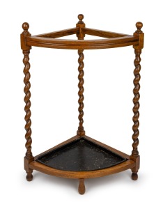 An antique English oak barley twist corner walking stick stand with metal drip tray, early 20th century, 76cm high, 54cm wide, 37cm deep.
