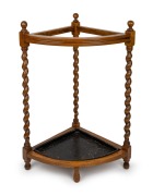 An antique English oak barley twist corner walking stick stand with metal drip tray, early 20th century, 76cm high, 54cm wide, 37cm deep.
