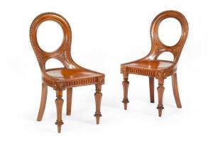 A quality pair of Australian Cedar hall chairs with large shaped seats, hand carved gadrooned shaped back with carved and fluted legs in original condition. These chairs are exceptionally crafted, possibly from the workshop of George Thwaites of Melbourne