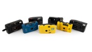 PLASTIC POINT-AND-SHOOT CAMERAS: Diverse 1980s-90s group comprising "Bananas in Pyjamas", Dulux PC-606, Hanimex EZ100, Kafon KA-501, Minolta FS-35, Minolta AFZ, and Panasonic C-410AF DX. (7 items)