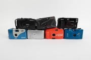 PLASTIC POINT-AND-SHOOT CAMERAS: 1980s-90s group comprising "Coca Cola", Dulux PC-606, Graflex Quantum 2000 AF, Hanimex EFP35, Hanimex Sensor (2), Hanimex Snapshot Brite, Nippon K-220, Panorama Wide Pic, Snap Sights (in underwater housing), and one anonym - 2