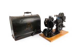 PATH&Eacute;: Hand-cranked KOK-type 28mm movie projector [#13628], c. 1910s, with attached 52.5 x 27cm baseboard, locking tin lid marked "Path&eacute; Kok Marque D&eacute;pos&eacute;e", together with "Asbestos Quarry in America" film reel.