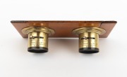 Stereo brass lens pair with iris diaphragms, mounted on board, late-19th century, both engraved "Harrington & Co - Photographic Merchants - Sydney". - 2