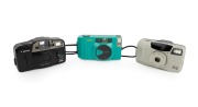 CANON: Group of 1990s-2000s plastic point-and-shoot cameras, comprising Snappy S (teal), Sure Shot 60 Zoom SAF, and Sure Shot Owl. (3 items)