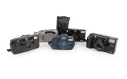 MINOLTA: Group of 1990s-2000s plastic point-and-shoot cameras, comprising AF-S, AF-Tele Super, Riva AF35, Supreme Freedom Zoom Elite (in matching pouch), and Vetis GX-1. (5 items)