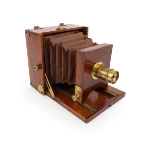 Late-19th century folding camera, plate dimensions 10.5 x 10.5cm, red bellows, uninscribed fixed-focus brass lens.
