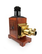 Large c. 1890s mahogany and brass MAGIC LANTERN with rack-and-pinion lens, tin chimney element, side-opening door with red glass peephole; engraved to front plate "T. Gaunt, Optician, Melbourne" (official watchmaker and optician to the Governor of Victori