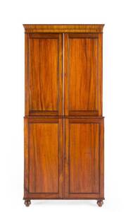 An important Australian Colonial solid cedar bookcase c1830s. Two blind panelled doors over panelled lower doors all resting on bun feet.PROVENANCE: Clifford Craig Collection, Sotheby's (Lot 22, 1994). Height 227, width 105cm, depth 37cm