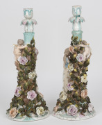 A pair of antique German porcelain figural candlesticks with applied floral decoration, 19th century, ​​​​​​​41cm high. - 2