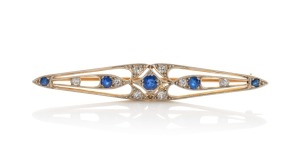 An Art Deco 18ct gold brooch with sapphires and diamonds mounted in white gold, circa 1920s, 5.5cm wide, 4.4 grams.