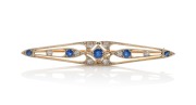 An Art Deco 18ct gold brooch with sapphires and diamonds mounted in white gold, circa 1920s, ​​​​​​​5.5cm wide, 4.4 grams.
