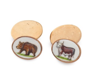 A pair of antique 9ct gold and hand-painted enamel cufflinks with bear and bull decoration, early 20th century, 11.1 grams total.