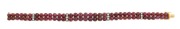 A stunning 18ct gold bracelet adorned with two rows of cabochon rubies interspersed with bands of white diamonds, early to mid 20th century, ​​​​​​​18cm long, 27.2 grams total.