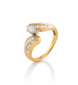 A vintage 14ct gold ring, set with a marquise diamond flanked by two rows of baguette cut white diamonds, stamped "14K", 4.5 grams total.