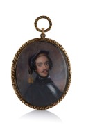An antique oval miniature mourning portrait of a man hand-painted on ivory with woven hair window on reverse, in a beautiful gold finished mount with pendant bow loop, early to mid 19th century, 8.5cm high overall.