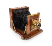 View camera, late 19th century, plate dimensions 12 x 16.5cm, uninscribed brass lens with aperture ring, "Baker & Rouse Melbourne & Adelaide" retailer's inlay.
