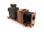 THORNTON-PICKARD: Large c. 1910s mahogany and brass "Imperial" ENLARGING MAGIC LANTERN with Aldis-Plano lens, twin bellows, and red glass peephole; later retrofitted for electricity, dimensions approx. 60 x 16 x 32cm.