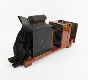 THORNTON-PICKARD: Large c. 1910s mahogany and brass "Imperial" ENLARGING MAGIC LANTERN with Aldis-Plano lens, twin bellows, and red glass peephole; later retrofitted for electricity, dimensions approx. 60 x 16 x 32cm. - 2
