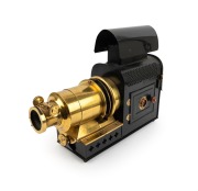 MAGIC LANTERN: Black-lacquered tin body, brass rack-and-pinion lens, dual side-opening doors with red glass peepholes, c. 1900s; an attractive example with ornate upper and lower ventilation holes; dimensions approx. 42 x 13 x 30cm.