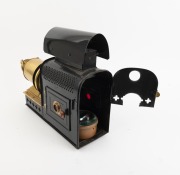 MAGIC LANTERN: Black-lacquered tin body, brass rack-and-pinion lens, dual side-opening doors with red glass peepholes, c. 1900s; an attractive example with ornate upper and lower ventilation holes; dimensions approx. 42 x 13 x 30cm. - 2