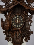 An impressive German Black Forest musical cuckoo wall clock, with dramatically carved linden wood case depicting game hunt animals, hunting horn and rifles, carved bone hands and Roman numerals, three weight movement with gong strike, cuckoo and pin barre - 2