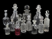 Thirteen assorted glass and crystal decanters, cruet bottles and vanity jars, 19th/20th century, the largest 22cm high.