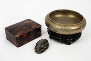 A vintage Chinese brass bowl on timber stand; together with an Egyptian style carved stone scarab beetle amulet and a faux tortoiseshell jewellery box, 20th century, (3 items), the bowl 24cm diameter.