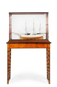 "VICTORY" model ship in cabinet on stand. Very unusual birdseye huon pine & ebonised harlequin legs with blackwood cross banding & cedar top. Second half of the 19th century. Height 162, width 105cm, depth 41cm.