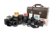 KONICA: FT-1 Motor SLR, c. 1983, in hard case with multiple lenses and accessories.