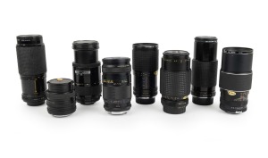 LENSES: Diverse c. 1980s group, all with lens filters fitted, most with front and/or rear cap; names include Auto Makinon MC, Auto-Promura, Prakticar MC Auto, Prinzflex, Sigma-XQ, and Sun C-A-D. (8 items)