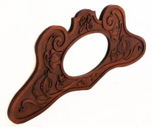 MIRROR in a shaped walnut frame carved with Australian Art Nouveau floral motif. Width 122, height 54cm