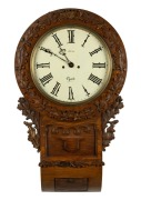 An antique English drop dial wall clock in carved oak case with two train fusee movement and Roman numerals, 19th century, 74cm high.