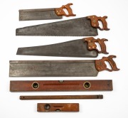 Four assorted hand saws, two spirit levels and a user made marking gauge, 19th/20th century, (7 items).