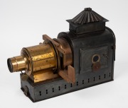 MAGIC LANTERN: Black-lacquered tin body, Voigtl&auml;nder brass rack-and-pinion lens, dual side-opening doors with blue glass peepholes, wooden slide holder in place, c. 1900s; dimensions 31 x 13 x 36cm. - 2