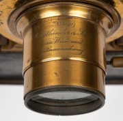 MAGIC LANTERN: Black-lacquered tin body, Voigtl&auml;nder brass rack-and-pinion lens, dual side-opening doors with blue glass peepholes, wooden slide holder in place, c. 1900s; dimensions 31 x 13 x 36cm. - 3