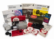 LEITZ: Group of movie-making items including Leicina 8SV, ST1 Electronic Control Unit (boxed), Universal Handgrip with Shoulder Stock [14 239], three lens hoods, a folder of ephemera, and others. (11 items, six of which in maker's boxes)