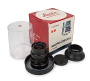 LEITZ: Macro-Cinegon 10mm f1.8 lens [#2526107], c. 1973, in Leitz lens capsule with Leica front cap, lens hood, and maker's box.