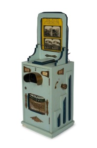PENNY ARCADE: "The Auto Stereoscope" early-20th century coin-operated hardwood tabletop stereoscope; rack of eighteen travel-themed stereo cards present; operates manually with One Penny coin, height approx. 96cm.
