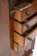 An antique English mahogany Wellington chest of seven graduated drawers with carved corbel decoration, bearing brass maker's plaque "W.H. TRAVERS, Endell St. & Castle St. Long Acre, W.C.", 19th century, 102cm high, 49cm wide, 36cm deep. - 2